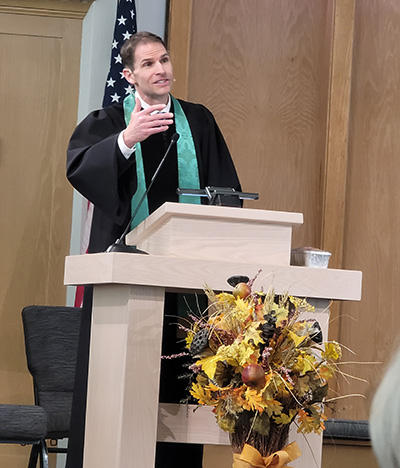 Pastor Galbraith preaching from the pulpit